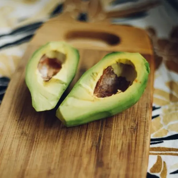 sliced avocado on wooden cutting board