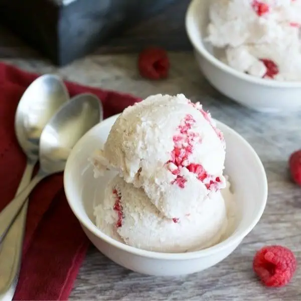white chocolate raspberry ice cream in white bowl
