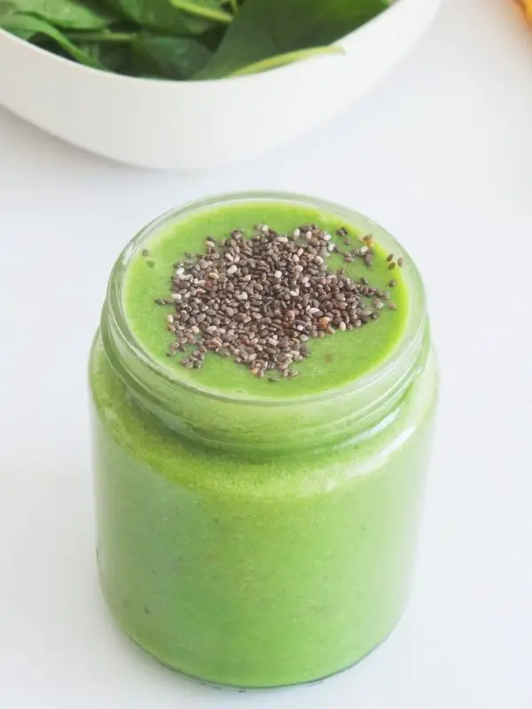 creamy cucumber green smoothie in glass with chia seeds