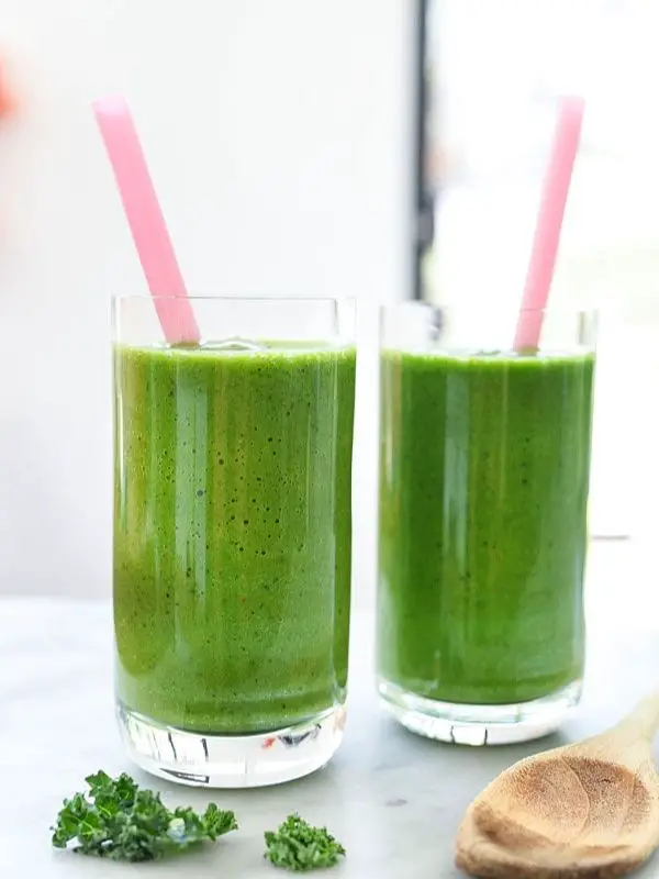 two immune booster green smoothies in tall glasses