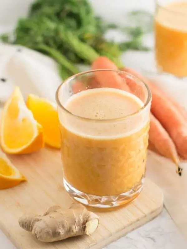 immune boosting orange smoothie with carrot and ginger in small glass