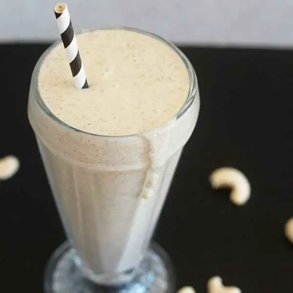 vegan vanilla cashew shake in glass with straw